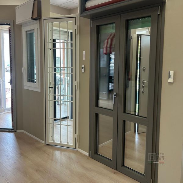 Finestra e porta finestra con grata nello show room di Profi System